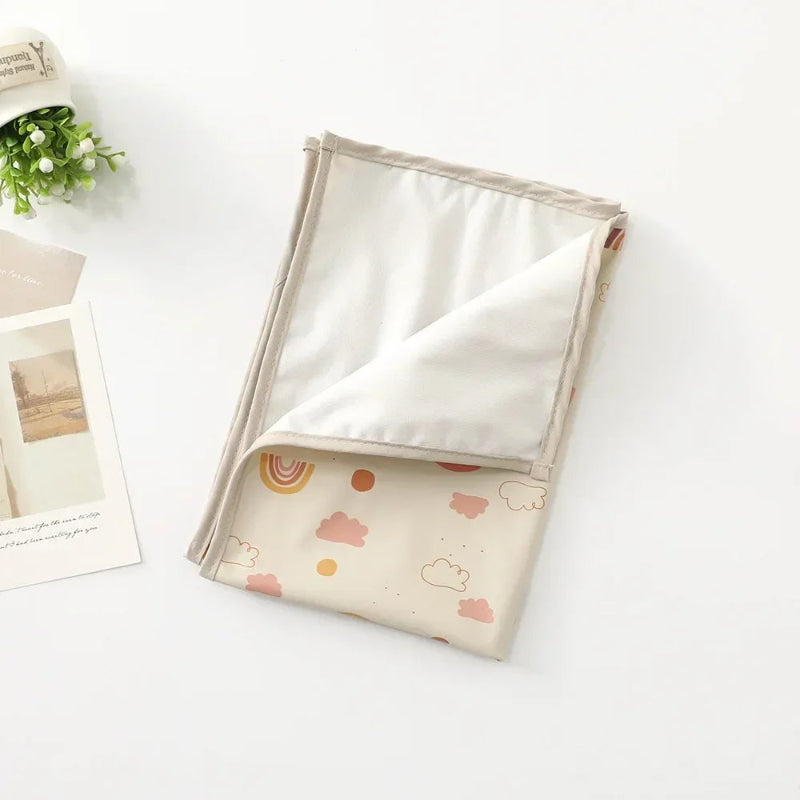 Tapis à langer nomade pour bébé arc-en-ciel