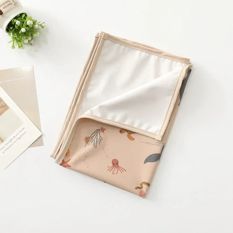 Tapis à langer nomade pour bébé Océan rose